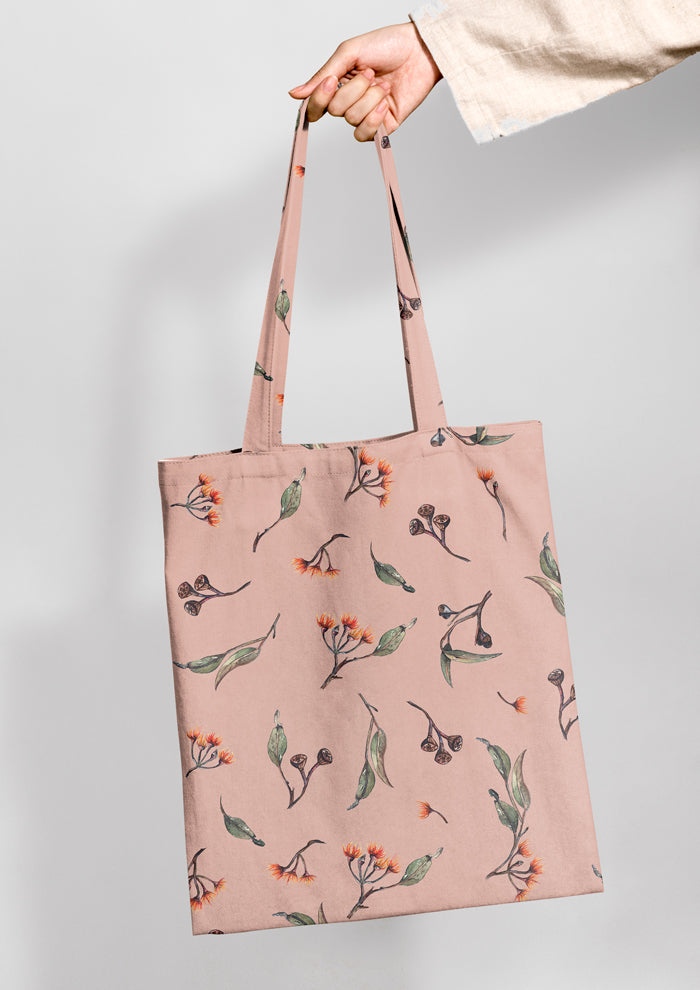 Tote bag featuring Eucalypt Echo pattern in a dusty pink palette, flowing eucalyptus elements spaced widely for dramatic impact on wallpaper or large fabric prints.