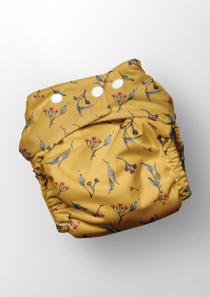 Eucalypt Echo pattern shown on a reusable nappy - scattered botanical elements for high-detail uses like stationery or children's clothing.