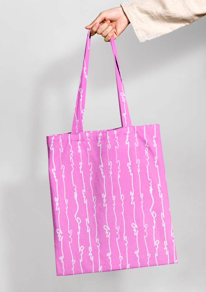 Tote bag mockup using Laura Hamzics Garden Squiggle pattern design in Pink