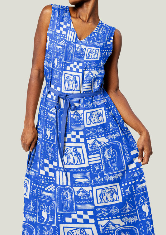 Woman wearing a blue patterned dress against a neutral background