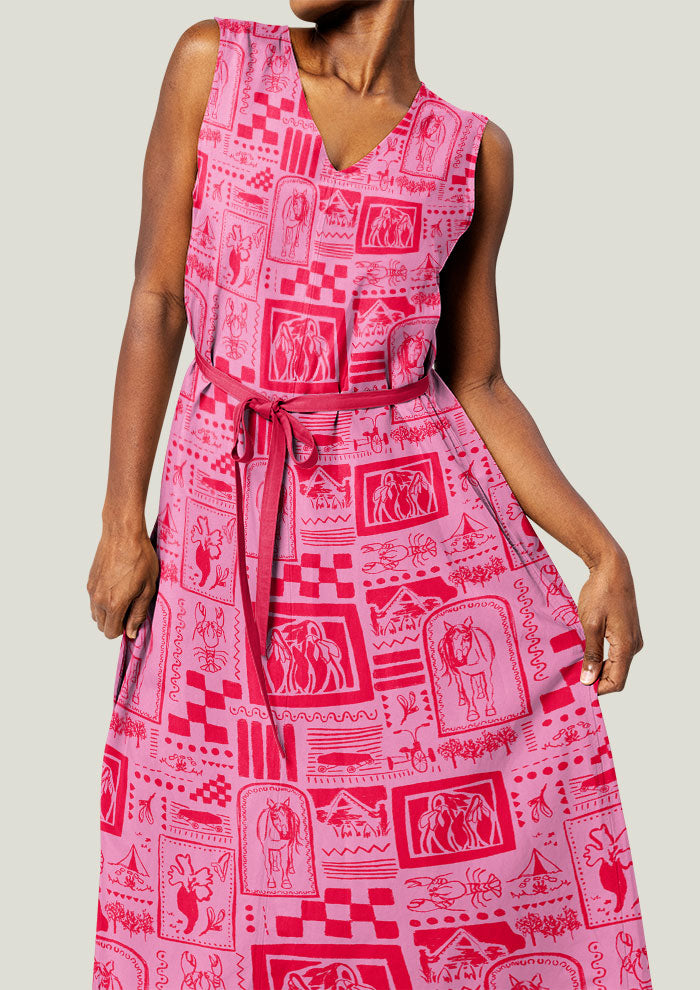 Pink patterned dress worn by a person on a plain background