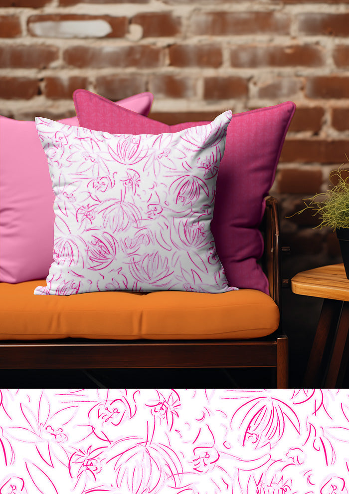 Floral-patterned pillow on a pink cushion with a brick wall background