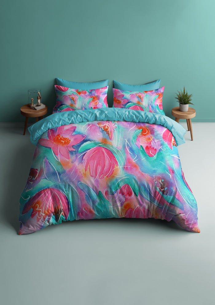 Bedding featuring Lily Lover pattern, bold, painterly water lilies in pink, teal, lilac, and yellow with soft white detailing, creating a striking design