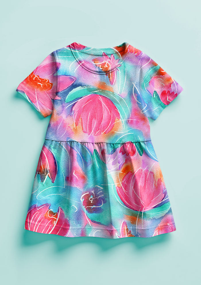 Girls Dress featuring Lily Lover pattern, bold, painterly water lilies in pink, teal, lilac, and yellow with soft white detailing, creating a striking design