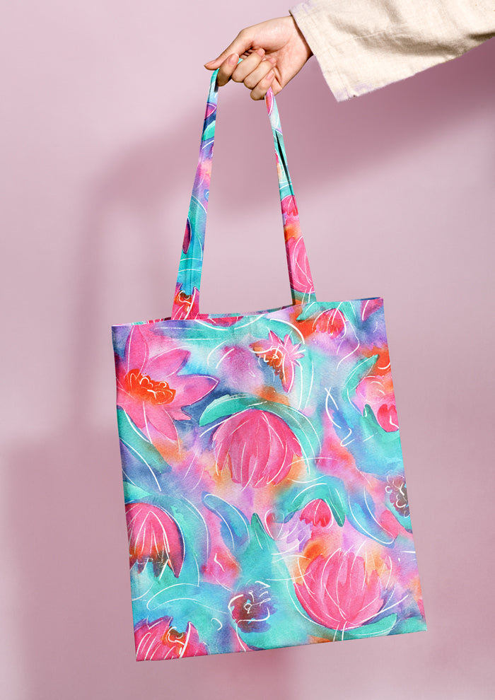 Shopping bag featuring Lily Lover pattern, bold, painterly water lilies in pink, teal, lilac, and yellow with soft white detailing, creating a striking design
