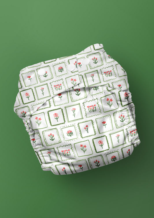Watercolour botanical nappy with lively framed floral print — unique Australian surface pattern design.