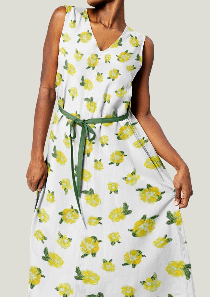 A bright yellow flower pattern scattered across the surface of a dress - pattern design by Laura Hamzic
