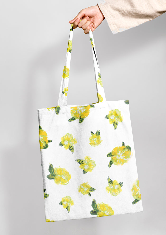 Tote bag mockup using Laura Hamzics Sun Sprinkle pattern design - Yellow blossoms on white