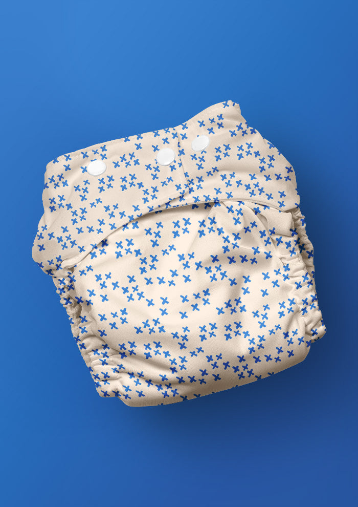 Baby nappy with X Marks the Spot pencil-drawn X pattern – bold sketchy design inspired by treasure hunts, adventurous Australian kidswear fabric, playful children’s accessories.