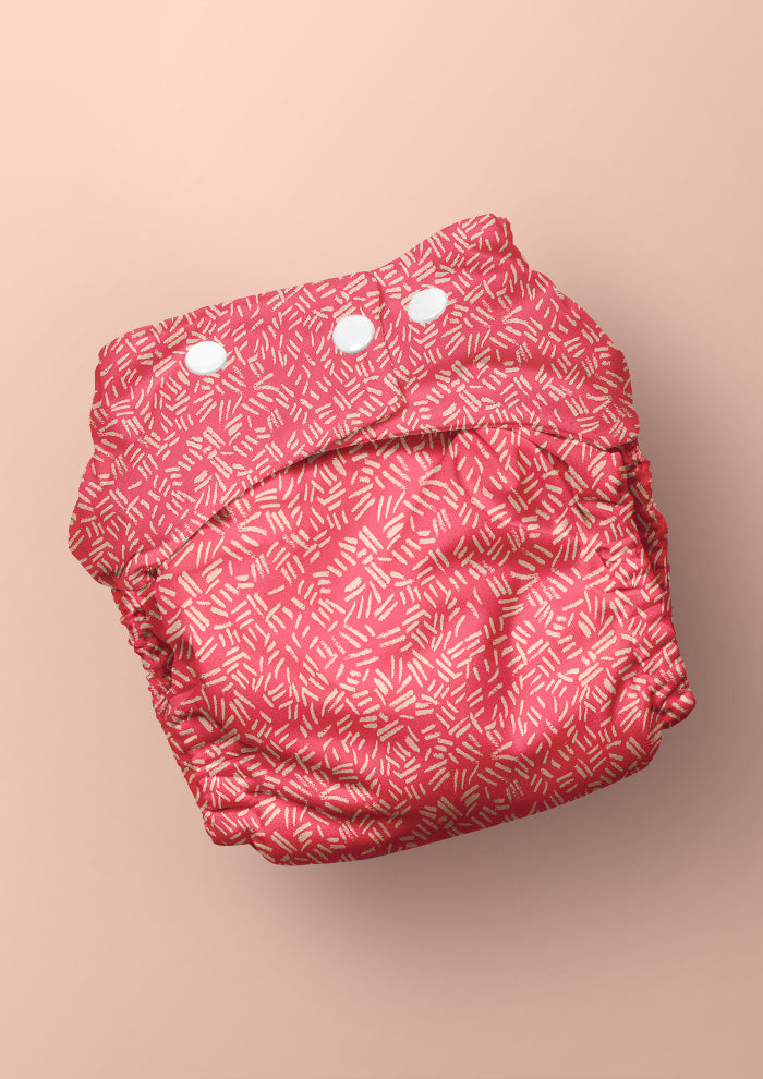 Baby nappy with earthy textured surface pattern – pencil-drawn marks inspired by cracked ground and natural bush etchings. Unique, adventurous design for kidswear and baby textiles.