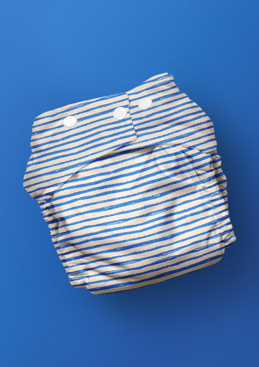 Baby nappy with Sandy Stripe hand-drawn stripe surface pattern – sketchy wobbly lines inspired by kids’ sandy trails, playful Australian kidswear fabric design.