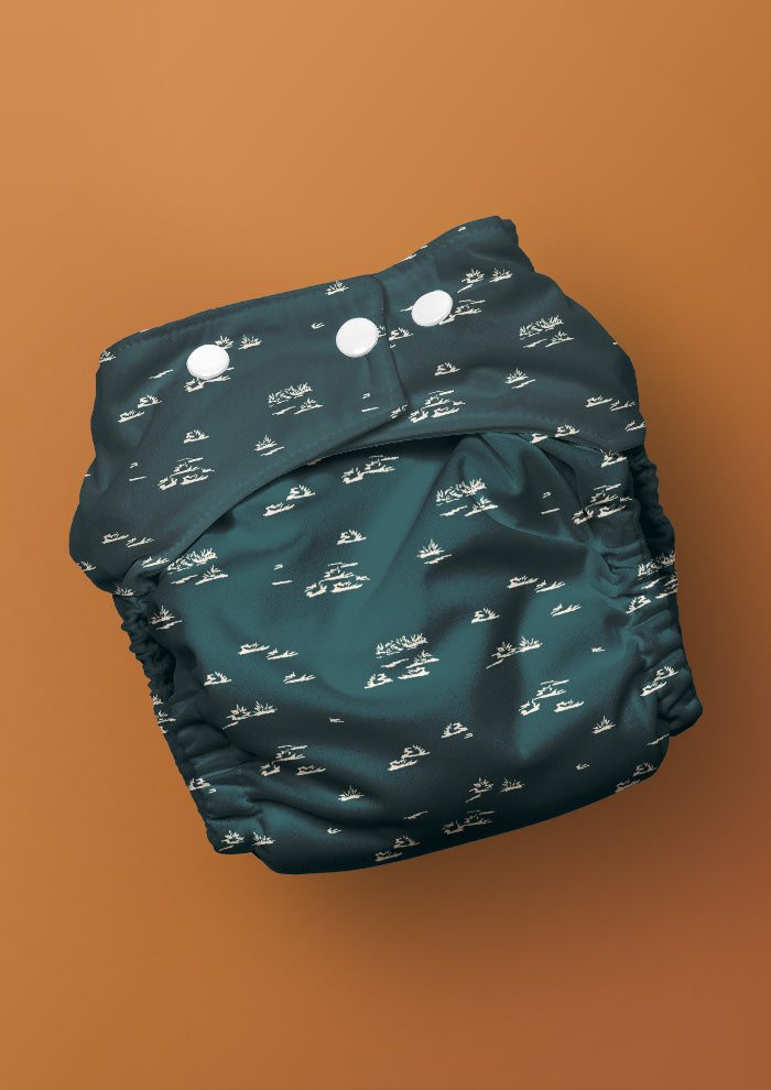 Baby nappy with Spinifex Scatter surface pattern – hand-drawn scraggly spinifex grasses in a playful, natural layout, Australian kidswear and baby fabric design.
