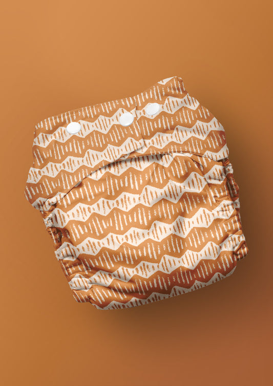 Baby nappy with Zig Zag Track energetic zig-zag surface pattern – coloured pencil texture, inspired by winding bushwalks and childhood discovery, playful Australian kidswear fabric design.