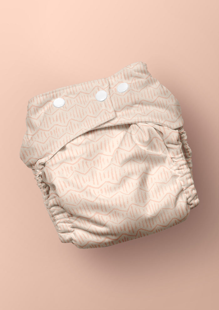 Baby nappy with Zig Zag Track energetic zig-zag surface pattern – coloured pencil texture, inspired by winding bushwalks and childhood discovery, playful Australian kidswear fabric design.