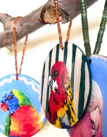 Close-up of Rosella Fella ornament showing glossy resin finish and handmade beaded hanger