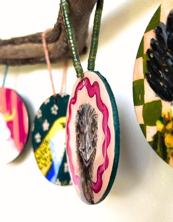Detail of Big Bird emu ornament showing glossy resin surface and handmade beaded hanger