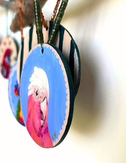 Detail of Pinkie galah ornament showing glossy resin finish and handmade beaded hanger
