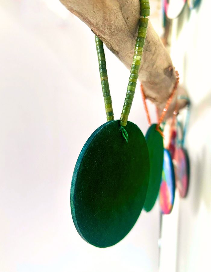 Back of hand-painted timber Christmas ornament showing soft velvet backing and handmade beaded hanging loop
