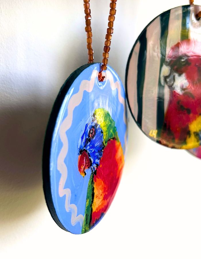 Detail of Rainbow Riot lorikeet ornament showing glossy resin surface and colourful beaded hanger