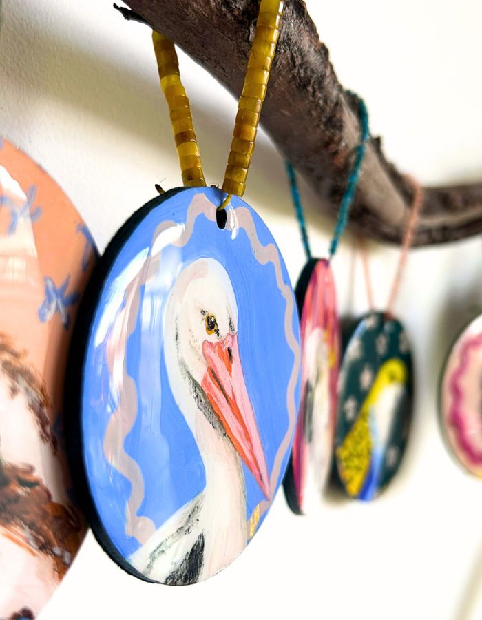 Detail of Pelican Pete ornament showing glossy resin finish and handmade beaded hanger
