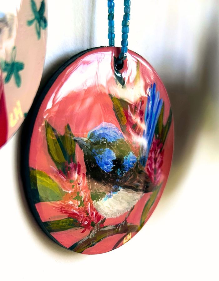 Detail of Tiny Dancer fairy-wren ornament showing glossy resin finish and handmade beaded hanger
