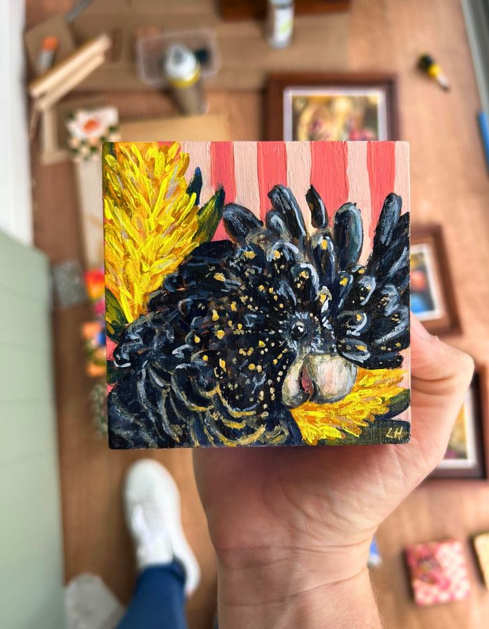 Original yellow-tailed black cockatoo painting held in hand
