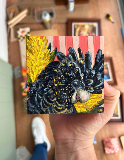 Original yellow-tailed black cockatoo painting held in hand