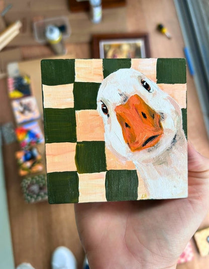 Original duck mini painting held in hand to show scale