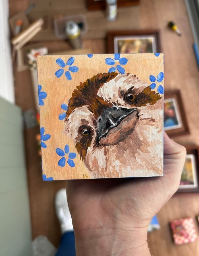 Kooky miniature original painting held in hand for scale