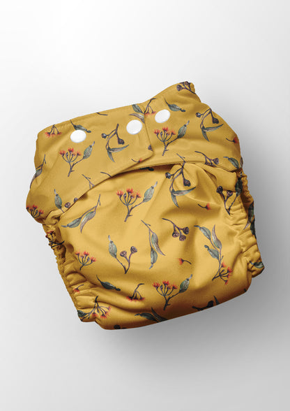 Eucalypt Echo pattern shown on a reusable nappy -  scattered botanical elements for high-detail uses like stationery or children's clothing.