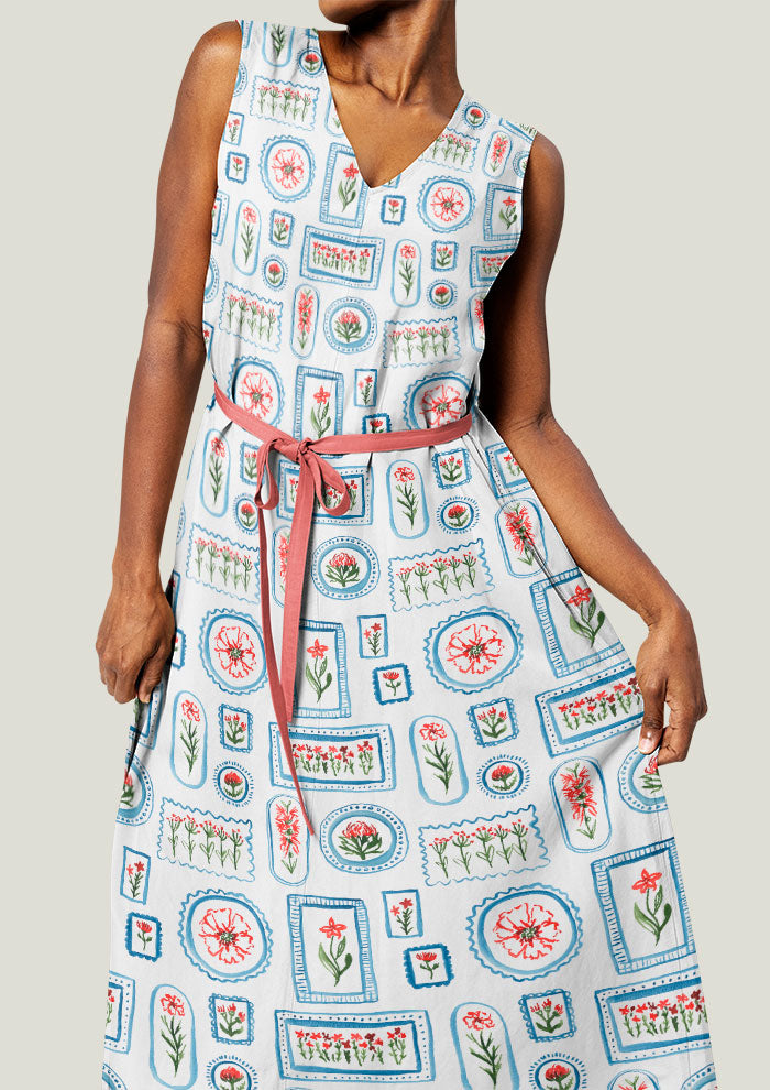 A playful watercolour pattern printed on linen dress featuring various flowers in frames in red, green and blue - artwork by Laura Hamzic Brisbane Surface Pattern Designer