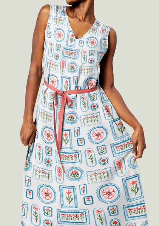A playful watercolour pattern printed on linen dress featuring various flowers in frames in red, green and blue - artwork by Laura Hamzic Brisbane Surface Pattern Designer