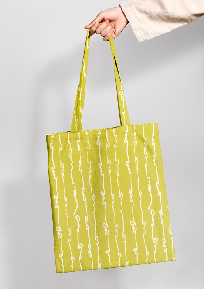 Tote bag mockup using Laura Hamzics Garden Squiggle pattern design in Yellow