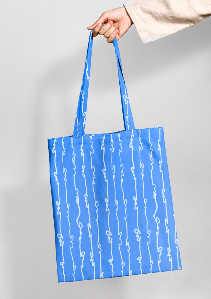Tote bag mockup using Laura Hamzics Garden Squiggle pattern design in blue
