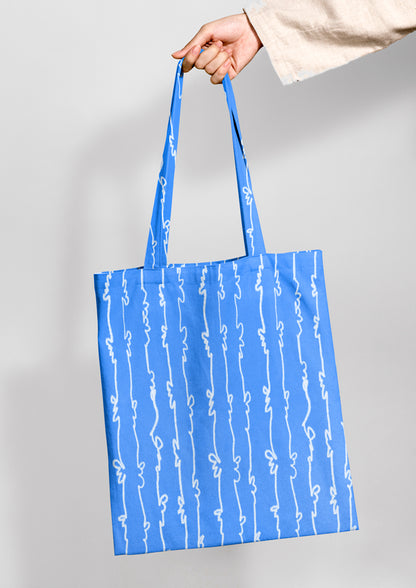Tote bag mockup using Laura Hamzics Garden Squiggle pattern design in blue