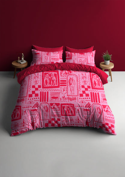Red and white patterned bedding set on a bed against a red wall.