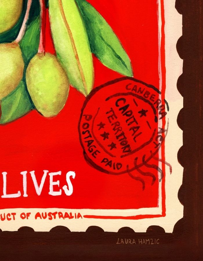 A close-up of a painted artwork featuring green olives on a red background with cream border elements, partial white text reading 'LIVES', a red postmark stamp, and the signature 'LAURA HAMZIC' at the bottom.