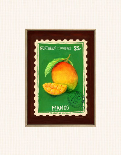 A framed vintage-style mango illustration print with a green background, a whole mango and a sliced mango, and the text 'NORTHERN TERRITORY 25c' and 'MANGO'. The print is mounted in a dark brown frame against a light off-white textured background.