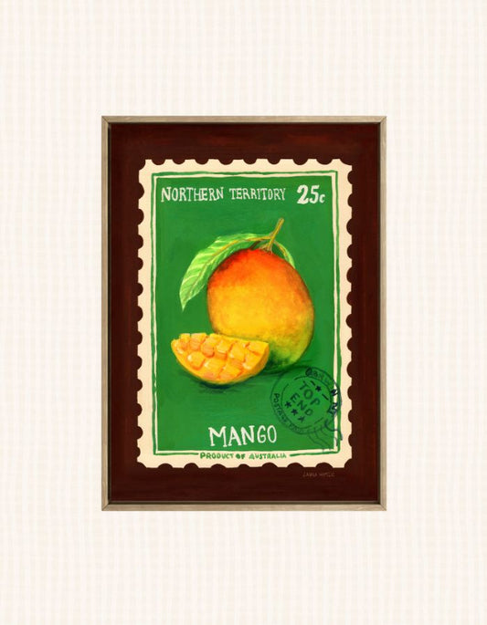 A framed vintage-style mango illustration print with a green background, a whole mango and a sliced mango, and the text 'NORTHERN TERRITORY 25c' and 'MANGO'. The print is mounted in a dark brown frame against a light off-white textured background.