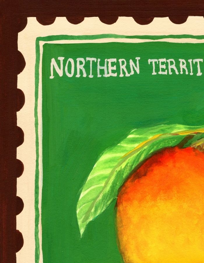 A close-up of a painted stamp-like design with the words "NORTHERN TERRITORY" on a green background, featuring part of an orange and a green leaf, with a dark brown border around it.