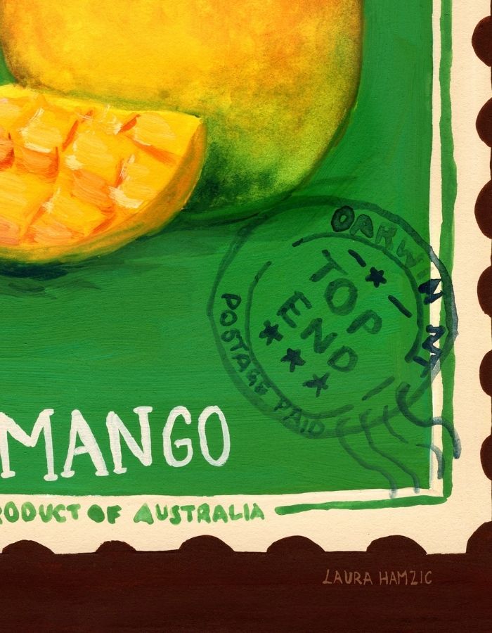A painted artwork of a mango, with a whole mango and a sliced mango in bright yellow and green tones on a green background. White text reads 'MANGO' and 'PRODUCT OF AUSTRALIA,' with a circular postmark reading 'TOP END POSTAGE PAID.