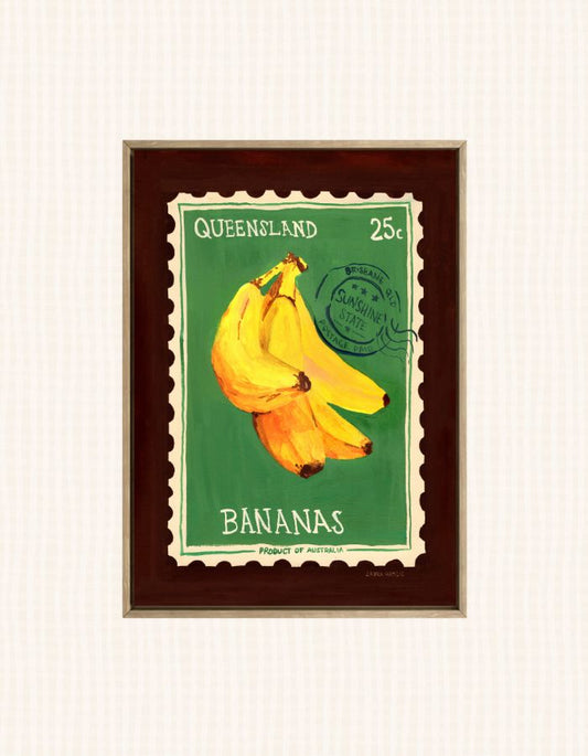 A framed art print depicting a vintage Queensland 25c banana stamp, featuring a bunch of yellow bananas on a green background with a dark brown frame.