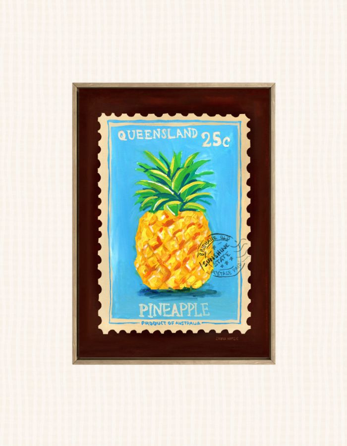 A framed art print depicting a vintage Queensland 25c postage stamp with a pineapple illustration, set against a light cream textured background.