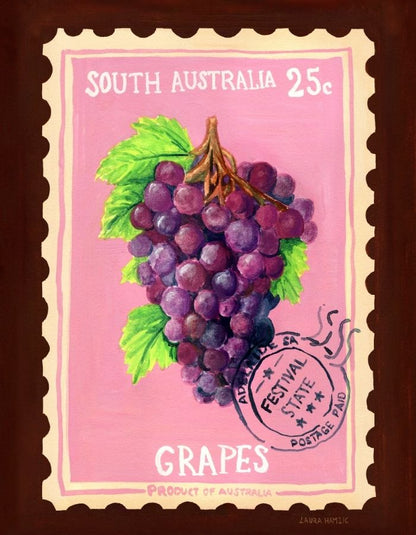 A framed art print depicting a vintage South Australia postage stamp illustration featuring a bunch of purple grapes on a pink background, with a dark brown frame around it.
