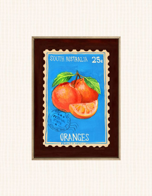 A framed vintage-style South Australia orange illustration print, featuring two oranges and an orange slice on a bright blue background with white text reading 'SOUTH AUSTRALIA 25¢' and 'ORANGES'.