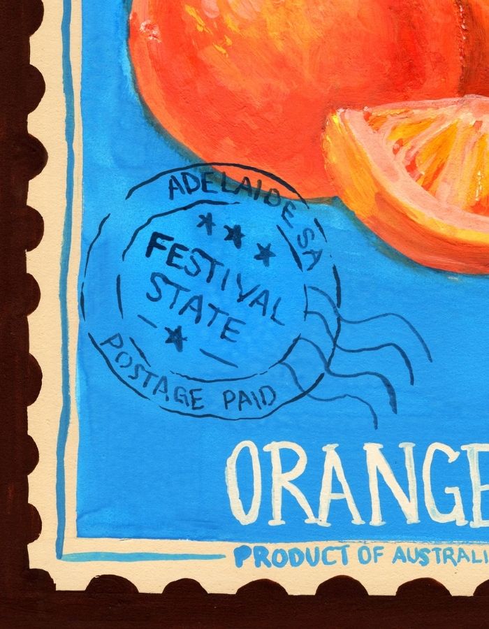 A close-up of a painted orange artwork with a bright blue background, part of a whole orange, an orange slice, and stylized text reading 'ORANGE' and 'Product of Australia.'.