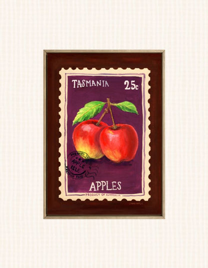 A framed art print depicting two red apples with green leaves on a purple stamp-like background, labeled 'TASMANIA 25c APPLES'. The print is housed in a dark brown wooden frame with a gold-toned inner border, set against a light cream textured background.