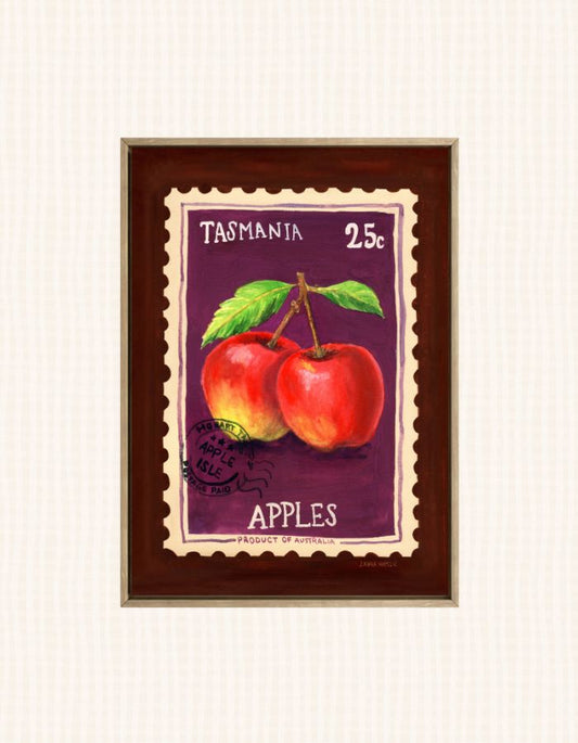 A framed art print depicting two red apples with green leaves on a purple stamp-like background, labeled 'TASMANIA 25c APPLES'. The print is housed in a dark brown wooden frame with a gold-toned inner border, set against a light cream textured background.