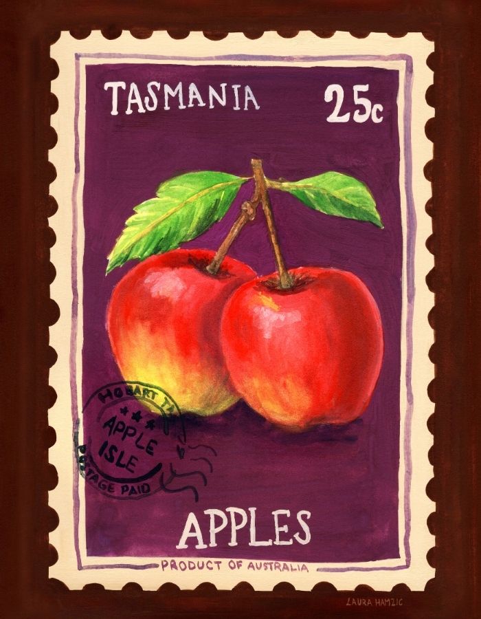 A framed artwork depicting two red apples with green leaves on a purple background, styled like a vintage Tasmania postage stamp with the text 'TASMANIA 25c APPLES' and a postmark. The piece is presented in a dark brown frame.