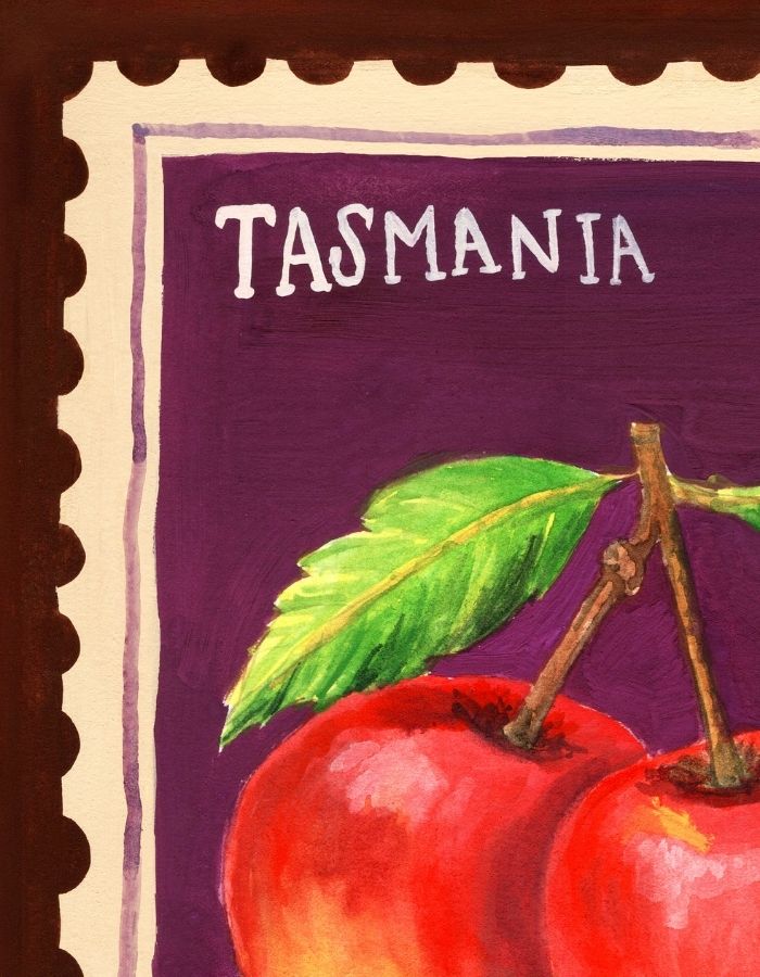 A close-up of a postage stamp-style artwork labeled "TASMANIA" on a purple background, featuring painted red apples with green leaves and a scalloped cream border.